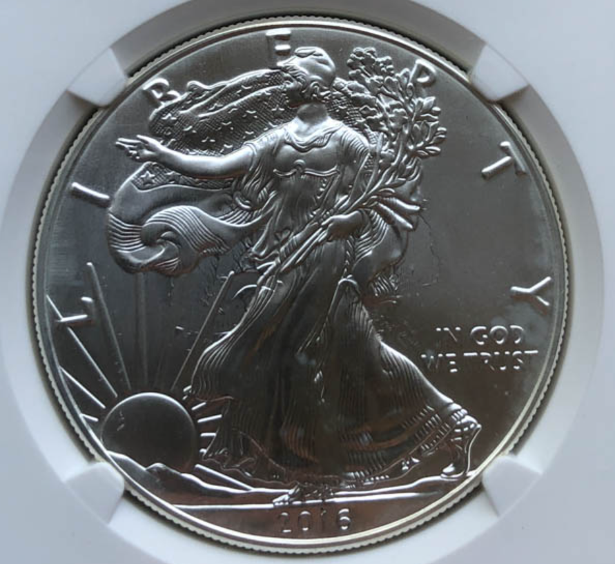 Close-up of 2016 American Silver Eagle obverse showing dramatic die clash error with eagle feather impressions transferred to Liberty side
